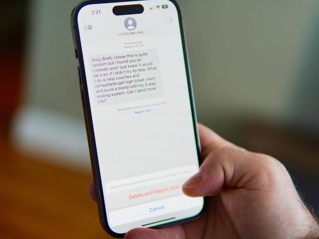 Hand holding a phone showing a text-message conversation